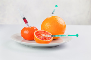fresh juicy oranges on a plate processed with chemicals