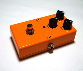 Orange effect pedal on a white background