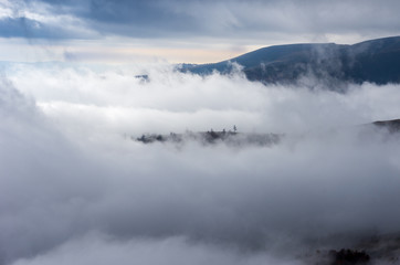 Be in the clouds. Island among the clouds. Mountain landscape among the clouds.