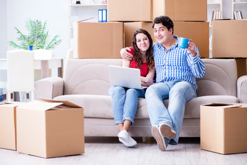 Young pair moving in to new house with boxes