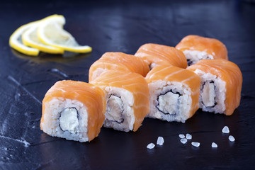 Sushi Philadelphia on a black plate.