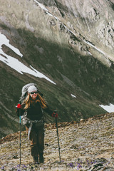 Young woman with backpack on hike in mountains Travel healthy lifestyle adventure concept active summer vacations outdoor