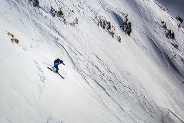 freerider skiing down through steep slope