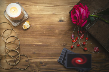 Tarot cards and book of magic on fortune teller desk table background. Love divination concept.