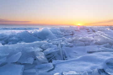 dawn at the frozen lake shore / in the direction of the sun