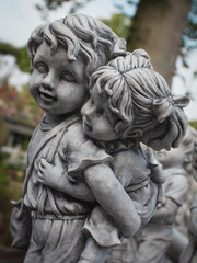 Image of two kids in the park, stone, close-up