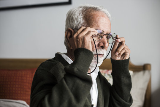 An elderly Indian man at the retirement house wearing a pair of spectacless