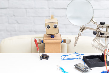 The robot collects the machine on a solar battery. Artificial Intelligence