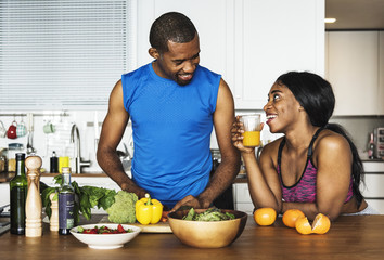 Black couple cooking healthy food in the kitchen