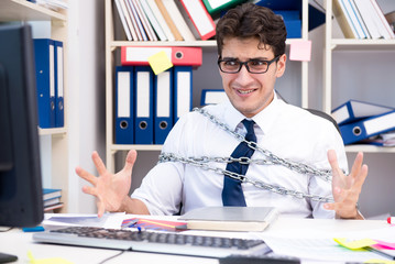 Employee attached and chained to his desk with chain