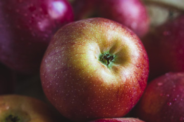 Delicious juicy apples. in a wooden basket. On a wooden table!
On a black background.