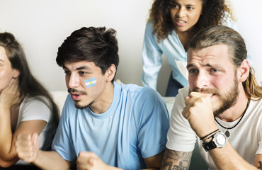 Friends cheering world cup with painted flag