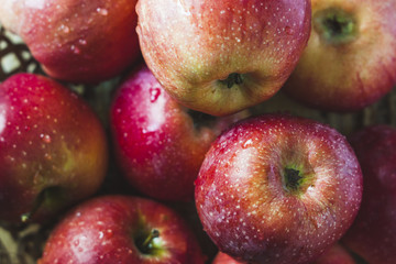 Delicious juicy apples. in a wooden basket. On a wooden table!
On a black background.