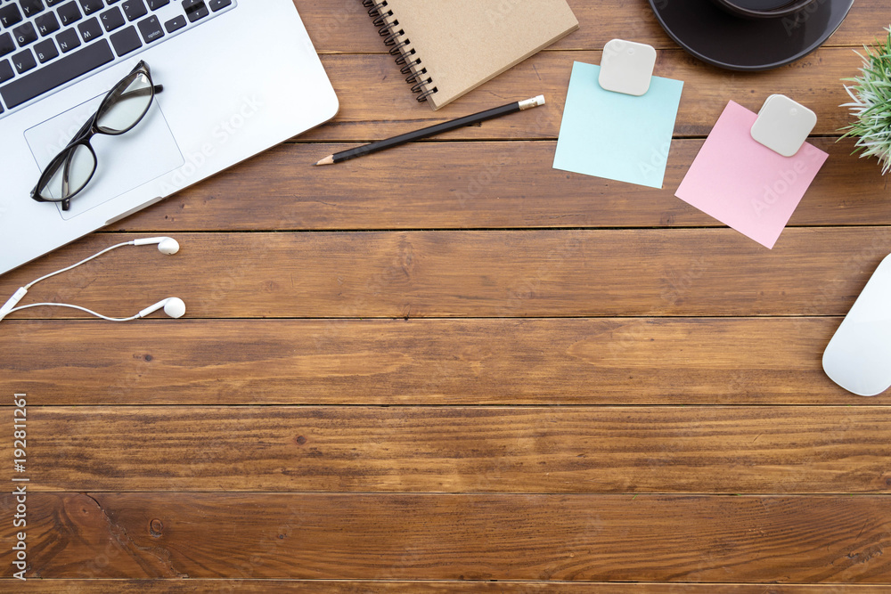 Poster flat lay of top view desk work table with computer laptop and stationary in home office on antique b