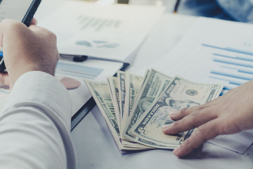 Businessman gives money to bribe corruption state official to avoid taxes and help decorate the disguised the company's financial accounts