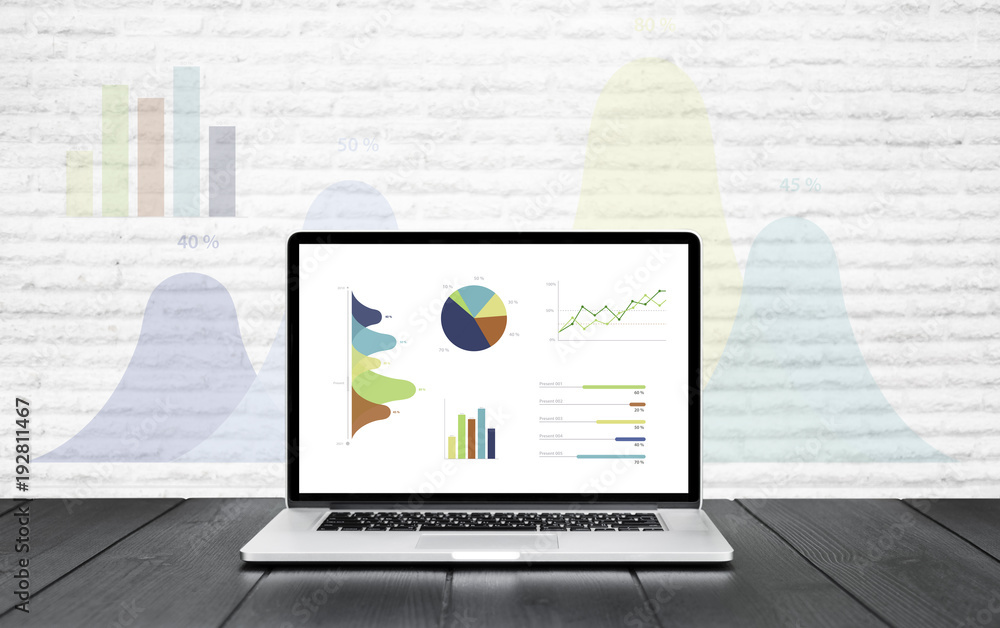 Aufkleber laptop on wooden table showing charts and graph colorful graphics background