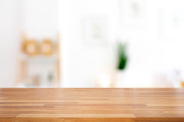 Empty wooden table with living room background