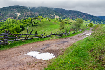 country road through rural area in mountains. beautiful landscape on a cloudy day in springtime