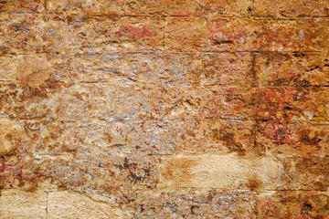 Empty old brick wall texture. Painted wall surface. Grungy brick wall. Building facade with damaged plaster.