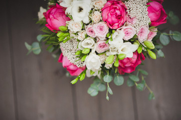 A beautiful, fresh bouquet for the bride with peonies. Lies on a blanket, on a chair, armchair. View from the top