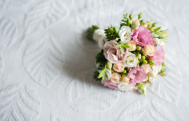A beautiful, fresh bouquet for the bride with peonies. Lies on a blanket, on a chair, armchair. View from the top