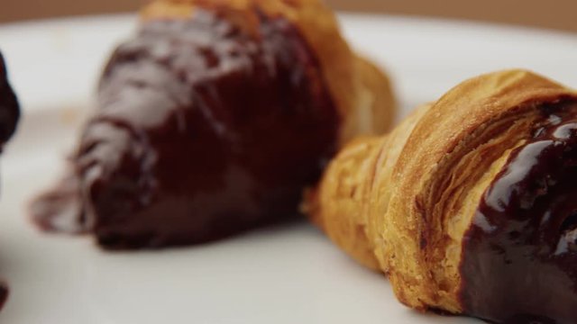 three croissant with a chocolate topping on a half