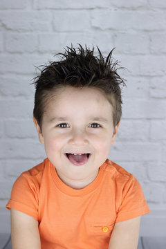 ni&ntilde;o con el pelo engominado echando la lengua
