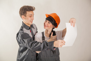 A young girl and a guy in uniform of workers. Working professions: painters, builders and others.