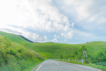 Beautiful  landscape view of  a country road and green grass with  blue sky  background of Utsukushigahara park is  one of the most important and popular natural place in Nagano Prefecture , Japan.