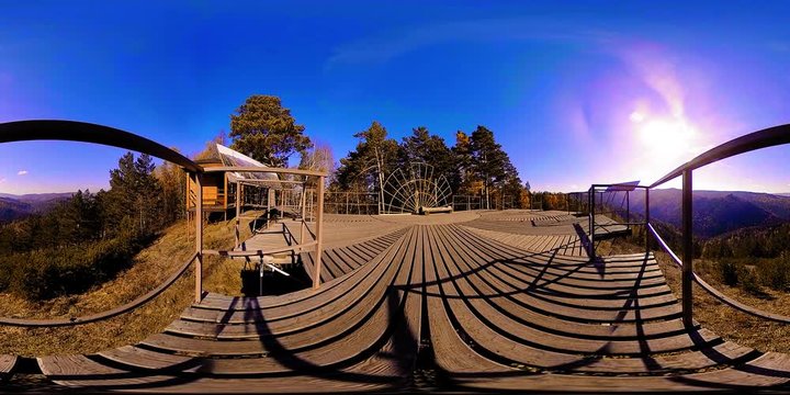 4K 360 VR virtual Reality of a beautiful mountain scene at the autumn time. Wild Russian mountains, pine forest and meadow. National park with paths and sun rays.