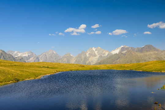 Beautiful mountain landscape. Lake in the mountains on the background of mountain peaks. Koruldi lake is a popular trekking route near the village of Mestia, Svaneti region, Georgia