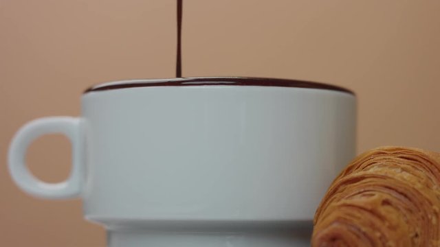 slowmotion of hot chocolate take out of cup making nice smooges on white cup