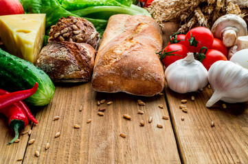 Set of vegetables with bread on a wooden board