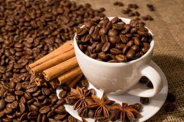 Coffee beans and coffee cup with cinnamon and anise