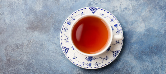 Cup of tea on a blue stone background. Copy space. Top view