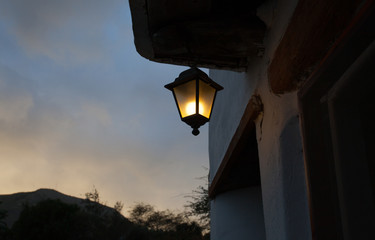Lit up lantern above a door at the entrance of a house in Lanzarote, Spain