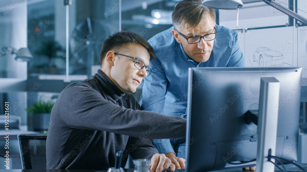 Poster experienced senior engineer consults young designer about project, they have discussion and work on 