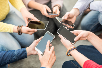 Friends having fun together with smartphones.