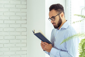 black man holding a book
