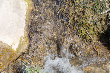Lake water flowing over stones.