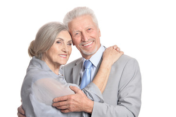 hugging senior couple on white background
