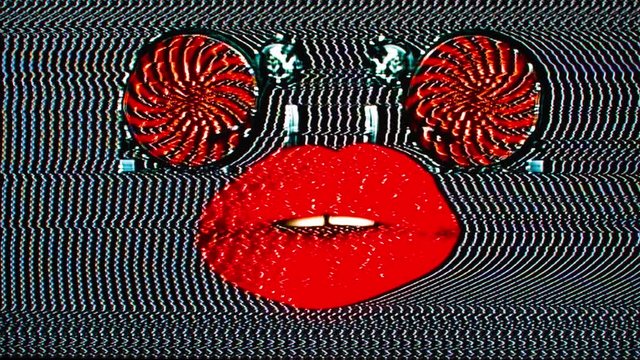 cutout of woman's beautiful full red lips with record turntables as eyes with overlayed video distortion and glitch effects.