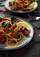 Homemade Pasta Spaghetti with mussels, tomato sauce, chilli and parsley on rustic background. sea food meal
