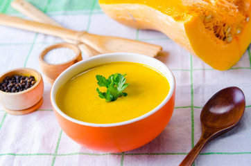 Pumpkin soup served on the table in bowl