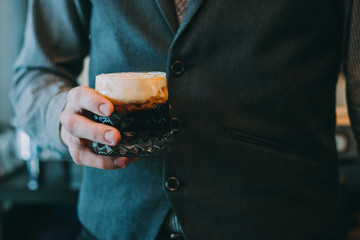 Alcohol cocktail on the bar. Bartender making an alcoholic cocktail. Irish cofee