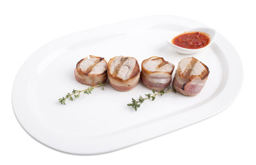 Grilled pork fillet wrapped in bacon.