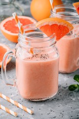 healthy detox smoothie in mason jar of red grapefruit with banana and chia seeds