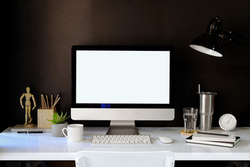 Stylish workspace mockup with desktop computer and designer craft accessories.