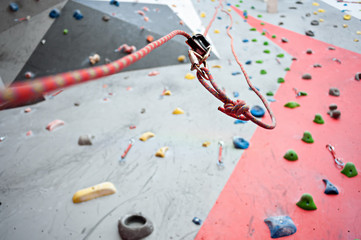 Climbing. A safety bolt threaded a rope with a carbine. Granite wall