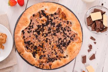 Sweet chocolate pizza with cookies. 